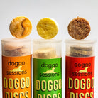 dog treats standing on top of dog treat tube containers